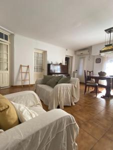 a living room with two beds and a table at Casa Arenales in Chascomús