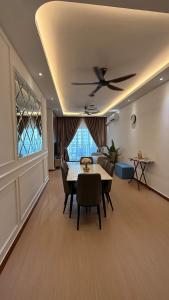 a living room with a table and a ceiling fan at SeFA Cozy Stay in Malacca