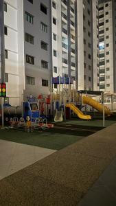 a playground in front of a tall building with a playground at SeFA Cozy Stay in Malacca