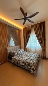a bedroom with a bed and a ceiling fan at SeFA Cozy Stay in Malacca