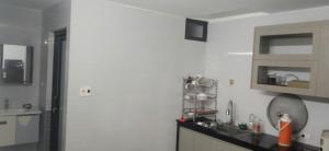 a white kitchen with a sink and a mirror at Kì thanh hotel in Thanh Hóa