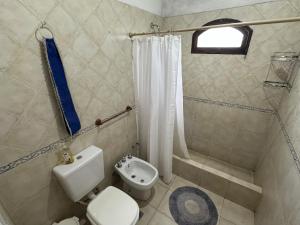a small bathroom with a toilet and a shower at Casa Tafi del Valle in Tafí del Valle +61 photos