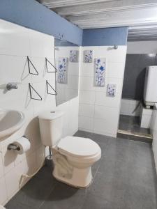 a bathroom with a toilet and a sink at Casa Terraza in El Zaino +13 photos