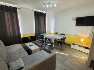 a living room with a couch and a table at Appart'hotel de la Roseraie in Belfort
