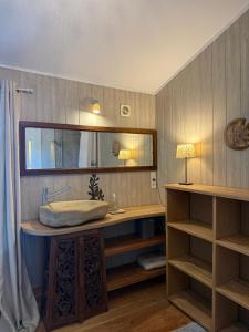 a bathroom with a sink and a mirror at La Source in Rustrel