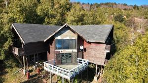 an aerial view of a house in the woods at casa caburgua en cerro in Caburgua