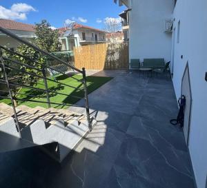 a view of a patio with stairs and grass at LĀr - the Hidden Gem in Anatolí