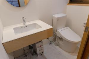 a bathroom with a sink and a toilet at まちやど半歩 in Shimo-suwa