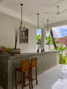 a kitchen with two chairs and a bar with a view at The weligama in Weligama