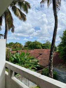 a view from the balcony of a house with palm trees at The weligama in Weligama