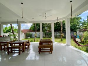 a dining room with tables and chairs and a large window at The weligama in Weligama