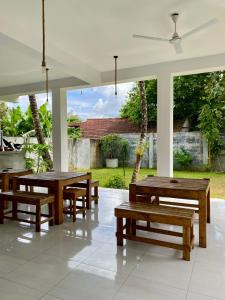 a group of tables and benches in a room at The weligama in Weligama