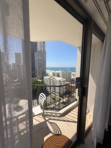 a balcony with a chair and a view of the city at Oceans 11 in Gold Coast