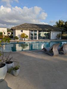 a villa with a swimming pool and a house at Beach House in Coronado in Nueva Gorgona