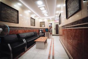 a waiting room with black leather chairs and a table at Star Luka Private Hotel Room 2 in Luxor