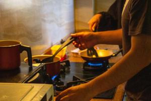 a person is preparing food in a kitchen at Casa Rumi - Guesthouse in La Paz +24 photos