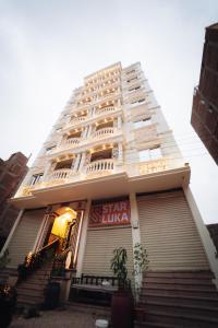 a large white building with stairs in front of it at Star Luka Private Hotel Room 2 in Luxor