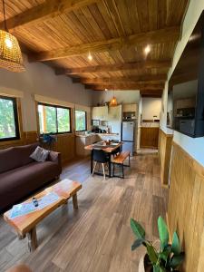 a living room with a couch and a table at Wincarayen Lodge & Cabañas in Panguipulli