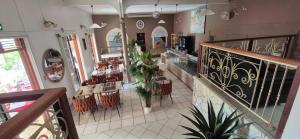 a restaurant with tables and chairs in a building at La Pointe d'Argent in Pointe-Noire