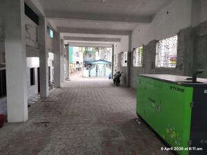 an empty hallway with a green counter in a building at Hotel Grand Arputha in Velankanni
