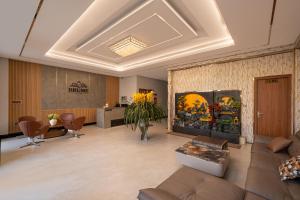 a living room with a couch and a fireplace at Khách sạn Brume Đà Lạt in Da Lat