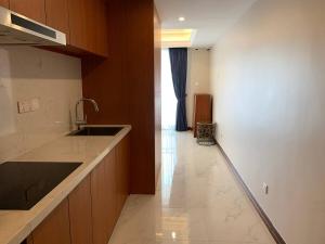 a kitchen with a sink and a counter top at Modern Condo in Phnom Penh ByDN in Phnom Penh