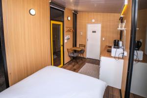 a small room with a bed and a kitchen at Gunyah by Tiny Away in Mount McDonald
