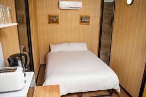 a small bedroom with a bed in a room at Gunyah by Tiny Away in Mount McDonald