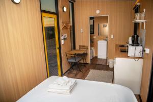 a room with a bed with towels on top of it at Gunyah by Tiny Away in Mount McDonald +18 photos