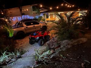 a wheeler parked in front of a house at night at Casa Maya Guesthouse in Mal País