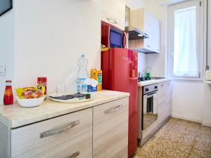 a kitchen with a red refrigerator and a counter at il 64B - 10 minuti a piedi dal Policlinico San Matteo - in Pavia