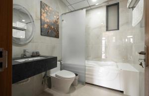 a bathroom with a toilet and a sink and a shower at Khách sạn Brume Đà Lạt in Da Lat