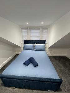 a large bed with a pair of jeans on it at Stylish 2BR Duplex - Central & Spacious in Sunderland