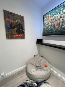a room with a dog bed in front of a tv at Stylish 2BR Duplex - Central & Spacious in Sunderland +9 photos