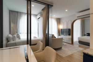 a hotel room with a bedroom and a living room at Above Element Bangtao Phuket by Arthouse Collection in Laguna Phuket
