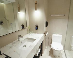 a white bathroom with a sink and a toilet at Perdana Kota Bharu in Kota Bharu