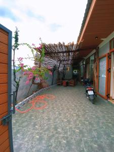 a building with a patio with flowers and plants at Góc Núi Homestay in Thôn Dư Khánh
