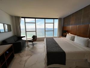 a hotel room with a large bed and a couch at Hotel Nacional in Rio de Janeiro +22 photos