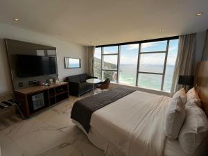 a hotel room with a bed and a large window at Hotel Nacional in Rio de Janeiro
