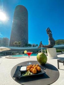 a plate of food on a table with a drink at Hotel Nacional in Rio de Janeiro