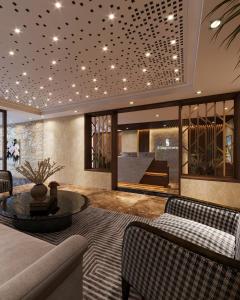 a living room with a couch and a table at Splendid Star Suite Hotel in Hanoi