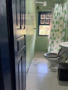 a bathroom with a toilet and a sink at Uai hostel in Ouro Preto +33 photos