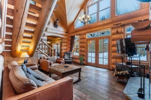 a living room with a couch and a tv at Fiddler Lake Resort - Bear 14 in Mille-Isles