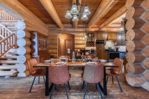 a dining room with a wooden table and chairs at Fiddler Lake Resort - Bear 14 in Mille-Isles
