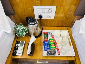 a table with a tray of food and drinks on a bed at Sairam Residency in Ellora