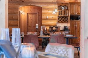 a dining room with wooden walls and tables and chairs at Fiddler Lake Resort - Bear 14 in Mille-Isles +21 photos