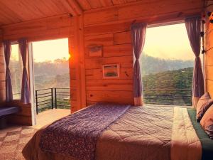 a bedroom with a bed in a cabin with a view at Mộc Lan’s House in Phi Liêng