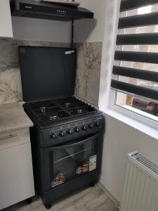 a black stove in a kitchen next to a window at Casa Lucy in Alexandria +4 photos