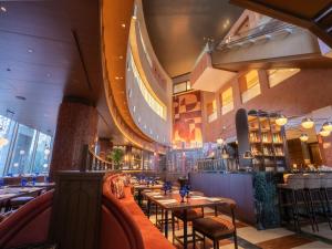a restaurant with tables and chairs in a building at The Mark Grand Hotel in Saitama