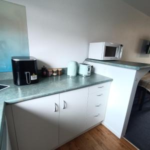 a kitchen with a counter top with a microwave at #4 Glenorchy Alpine Suite in Glenorchy